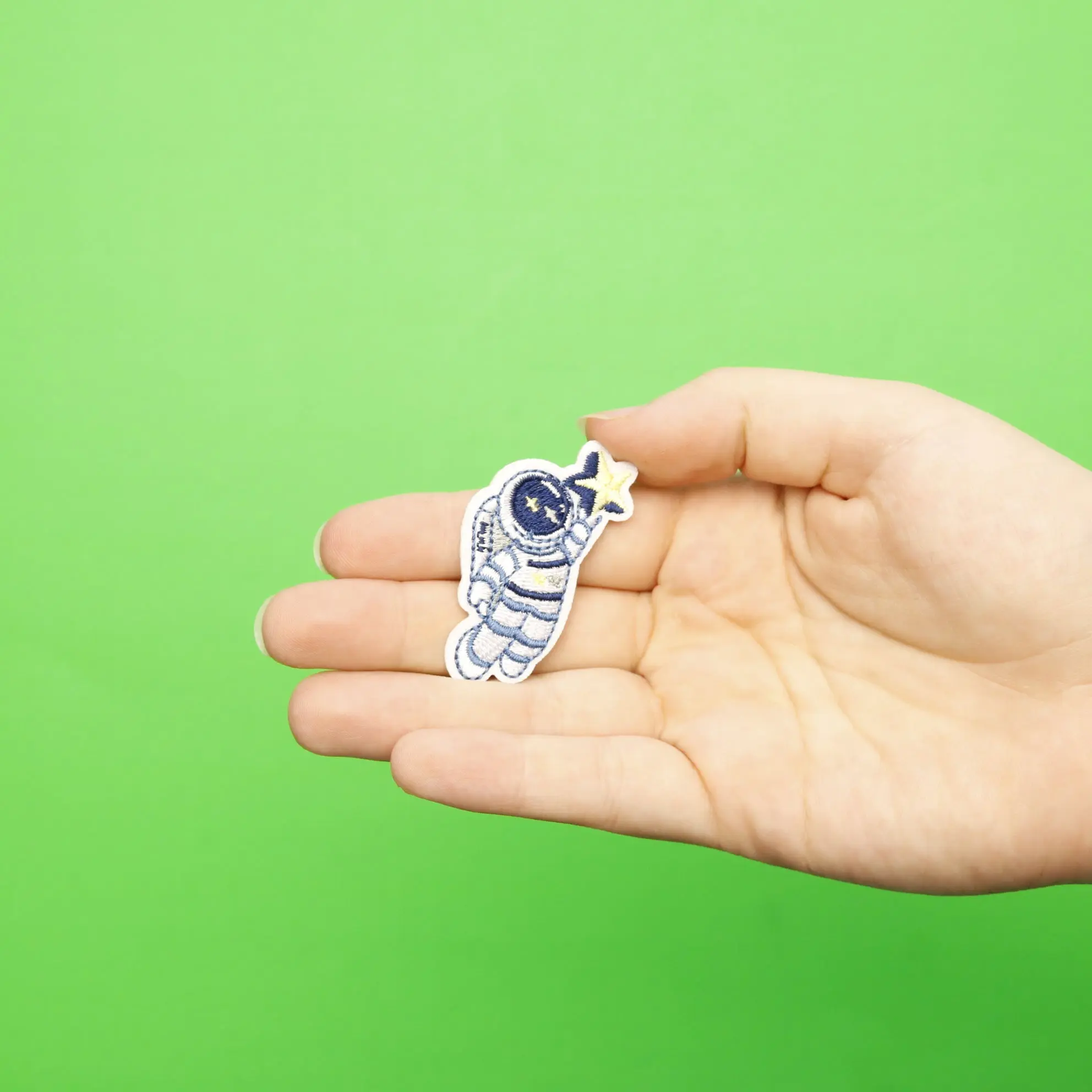 Small Blue Astronaut Holding A Star Embroidered Iron On Patch - Image 2