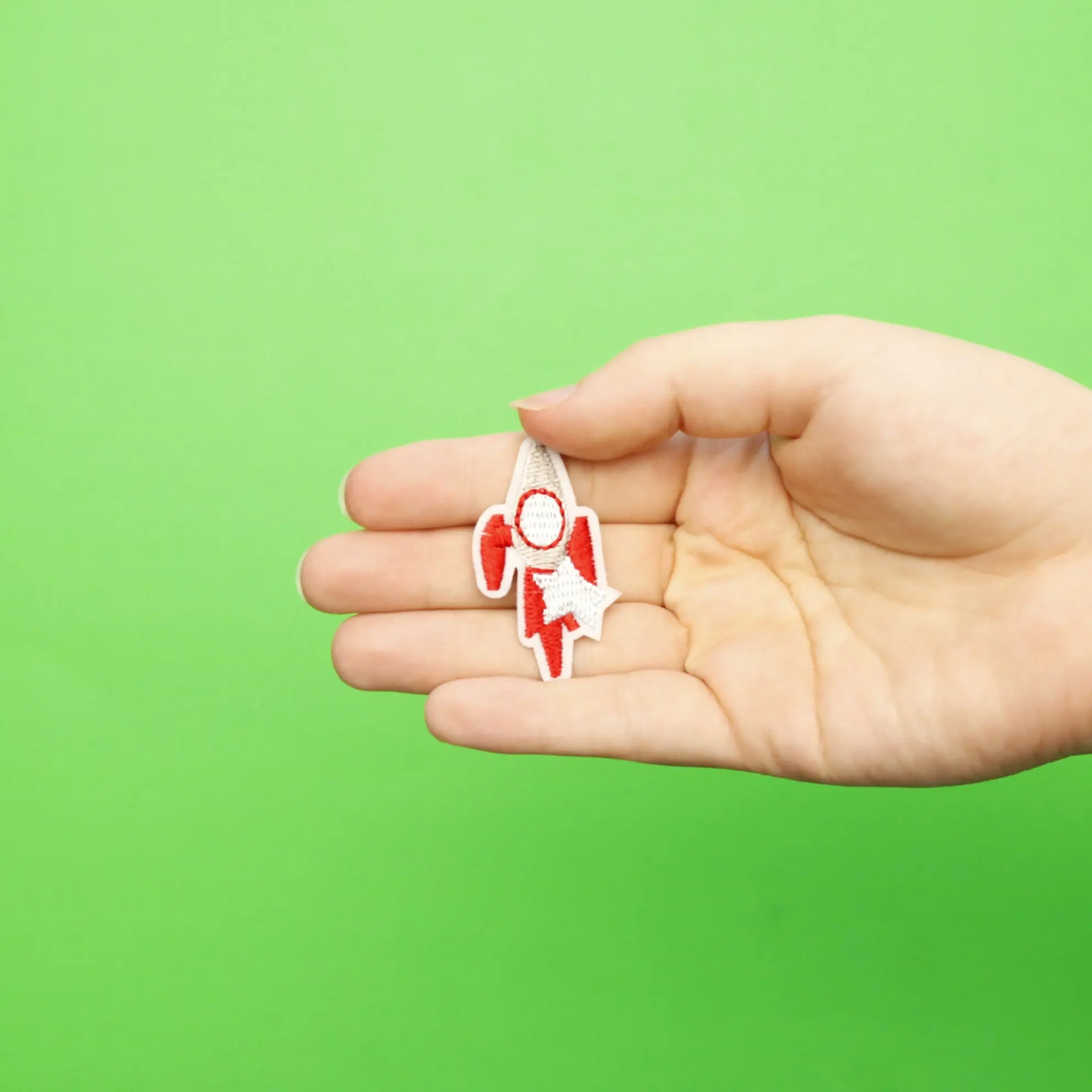 Small Red Rocket Ship With A Star Embroidered Iron On Patch - Image 2